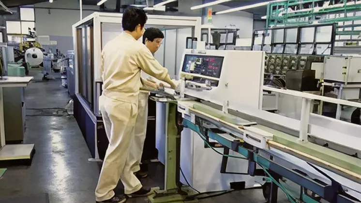 Checking gauges beside a running cut machine